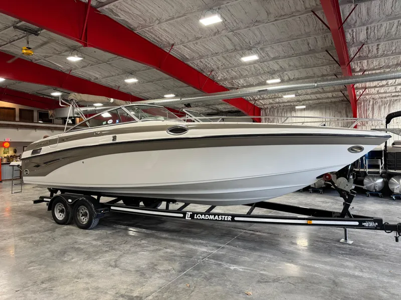 Slide: The Image of 2003 Crownline 280 BR boat on Loadmaster trailer in indoor storage facility. - 2