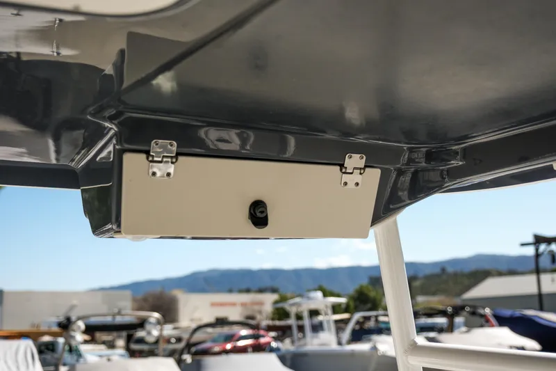 Slide: The Image of 2022 Robalo R247 Dual Console boat storage compartment under hardtop. - 10