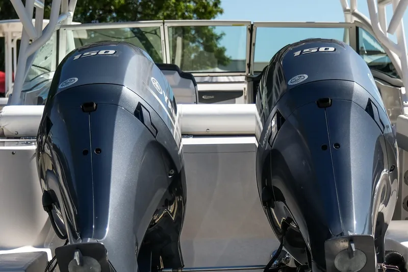 Slide: The Image of 2022 Robalo R247 Dual Console with twin 150 horsepower engines, rear view. - 19