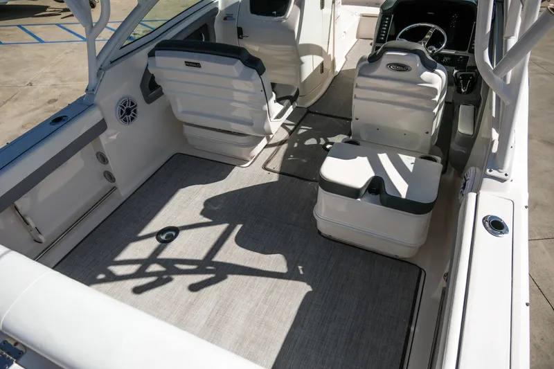 Slide: The Image of 2022 Robalo R247 Dual Console boat interior with seating and steering console. - 20