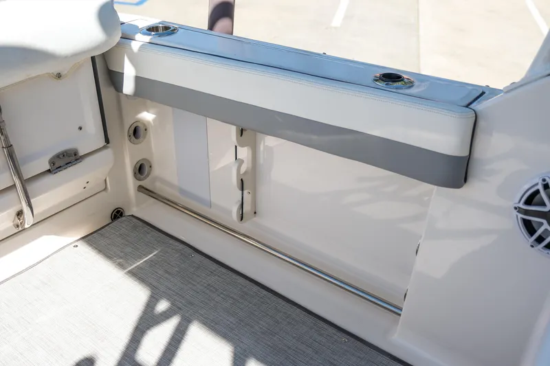 Slide: The Image of 2022 Robalo R247 Dual Console interior with seating and storage features. - 21