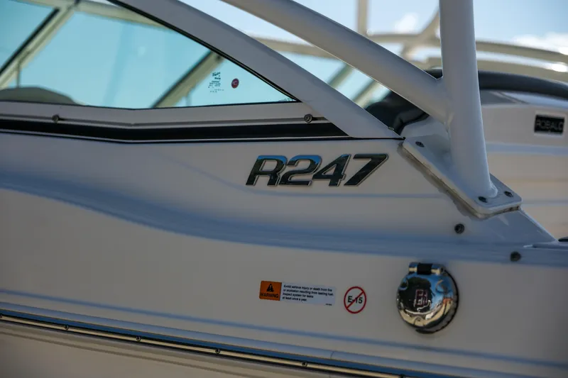 Slide: The Image of 2022 Robalo R247 Dual Console boat, close-up of model name on the side. - 26