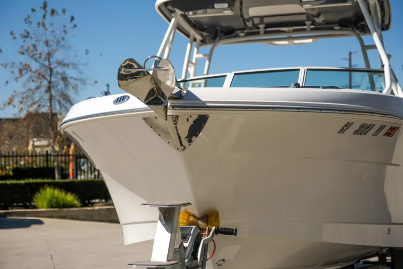 Slide: The Image of 2022 Robalo R247 Dual Console boat, front view, docked outdoors on a sunny day. - 9