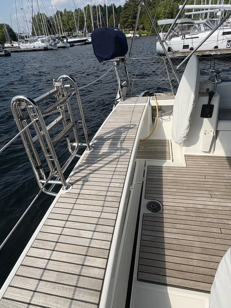Slide: The Image of Beneteau Oceanis 45 yacht deck, 2018 model, docked at marina with sailboats. - 10