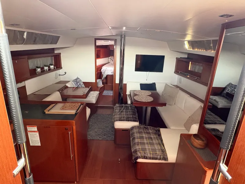 Slide: The Image of Interior of 2018 Beneteau Oceanis 45 yacht with modern furnishings and cozy seating area. - 14