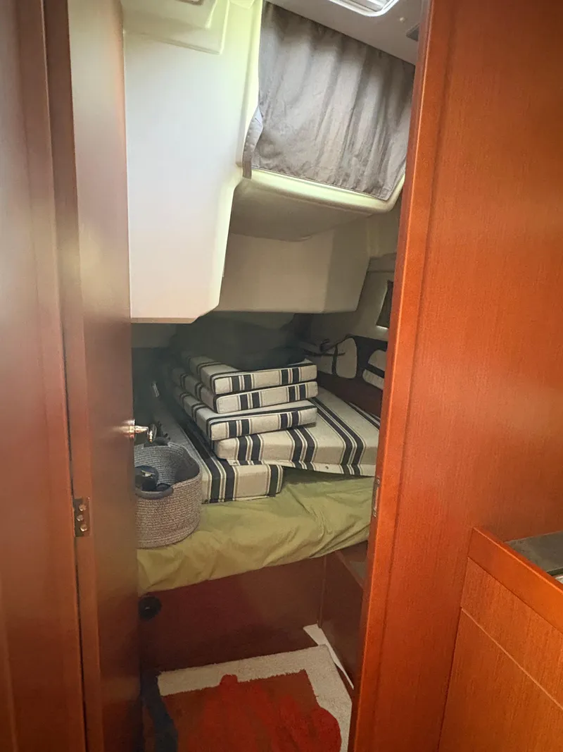 Slide: The Image of Cozy cabin interior of 2018 Beneteau Oceanis 45 with striped cushions. - 15