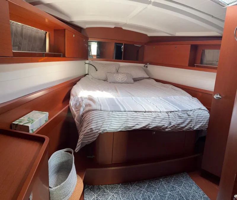 Slide: The Image of Cozy cabin interior of 2018 Beneteau Oceanis 45 yacht with striped bedding. - 17