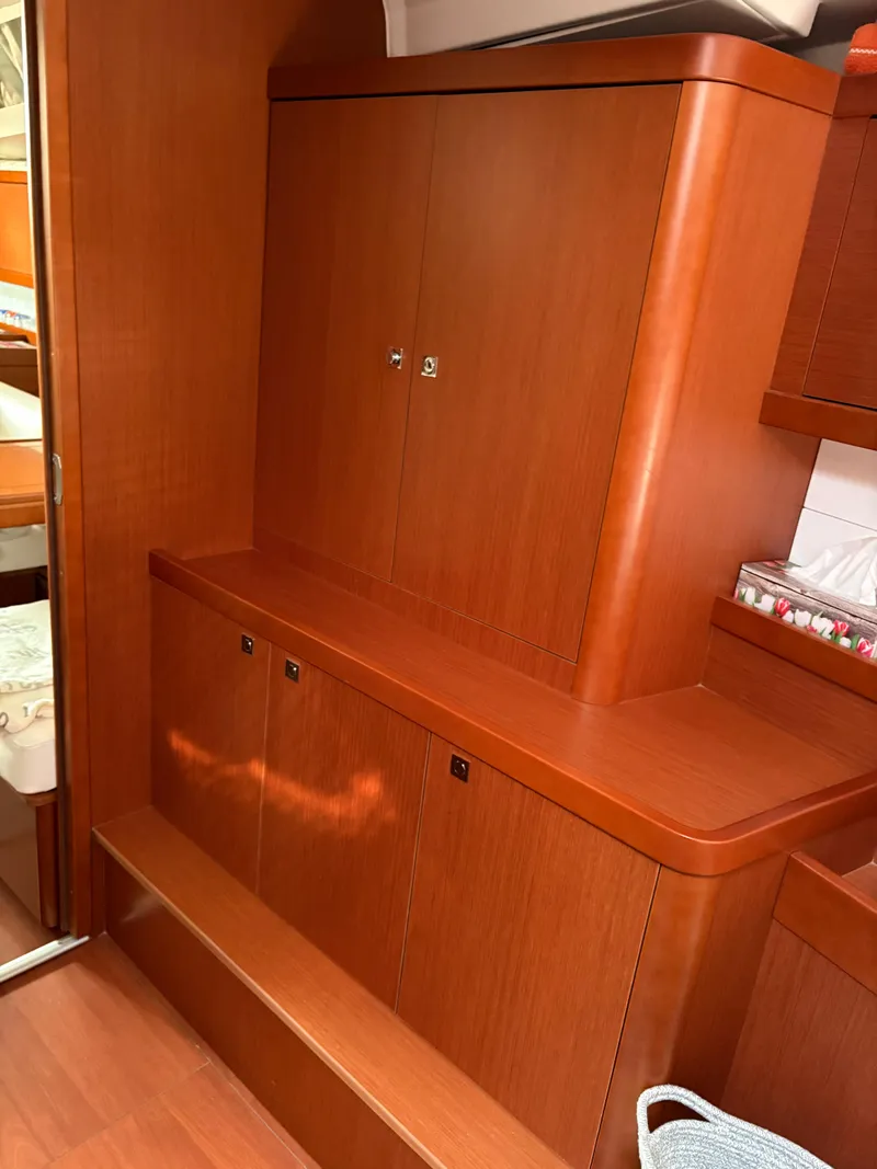 Slide: The Image of Interior of 2018 Beneteau Oceanis 45 yacht with wooden cabinetry and storage. - 18