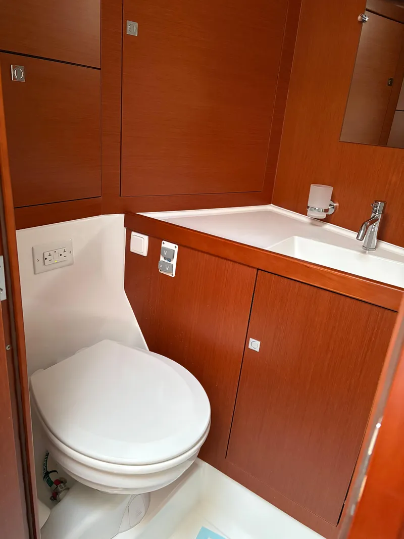 Slide: The Image of 2018 Beneteau Oceanis 45 yacht bathroom with wooden cabinetry and modern fixtures. - 19