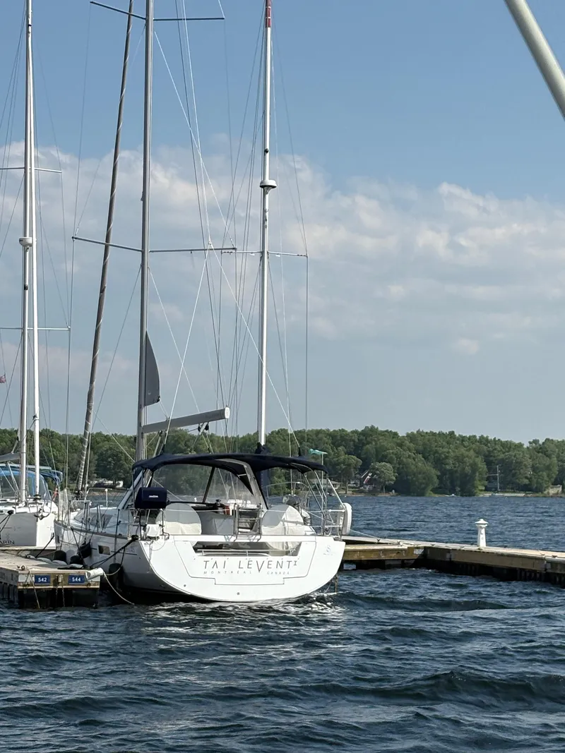 Slide: The Image of 2018 Beneteau Oceanis 45 sailboat docked on a sunny day with blue skies. - 2