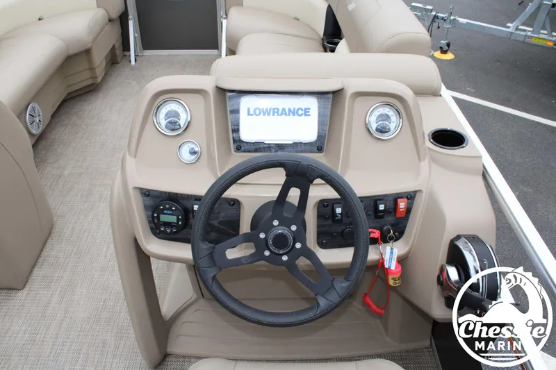 Slide: The Image of 2022 Starcraft LX 22 R boat dashboard with steering wheel and Lowrance display. - 13
