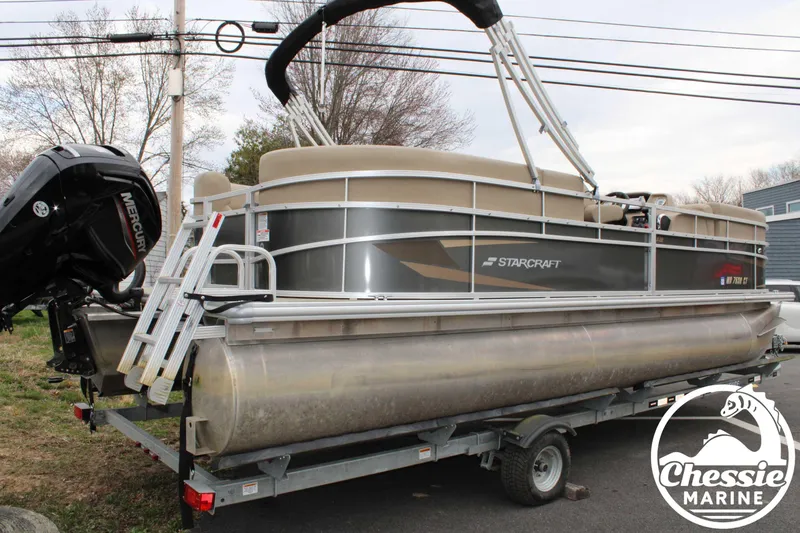 Slide: The Image of 2022 Starcraft LX 22 R pontoon boat on trailer with Mercury outboard motor. - 3