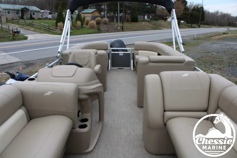 Slide: The Image of 2022 Starcraft LX 22 R pontoon boat with beige seating and open deck layout. - 7