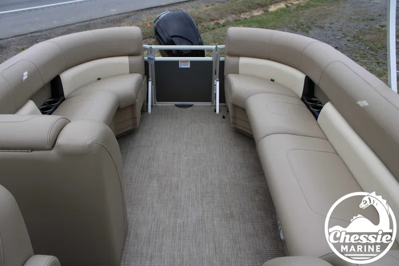 Slide: The Image of 2022 Starcraft LX 22 R pontoon boat interior with beige seating and carpet flooring. - 8