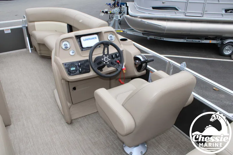 Slide: The Image of 2022 Starcraft LX 22 R pontoon boat interior with steering console and seating. - 9