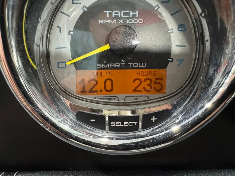 Slide: The Image of Tachometer of 2011 Sea Ray 250 SLX showing 12 volts and 235 hours. - 11