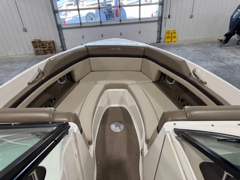 Slide: The Image of 2011 Sea Ray 250 SLX boat interior with beige seating and stainless steel accents. - 7