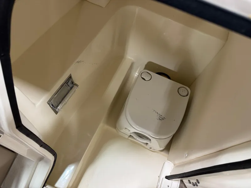 Slide: The Image of 2011 Sea Ray 250 SLX boat interior with compact marine toilet. - 9