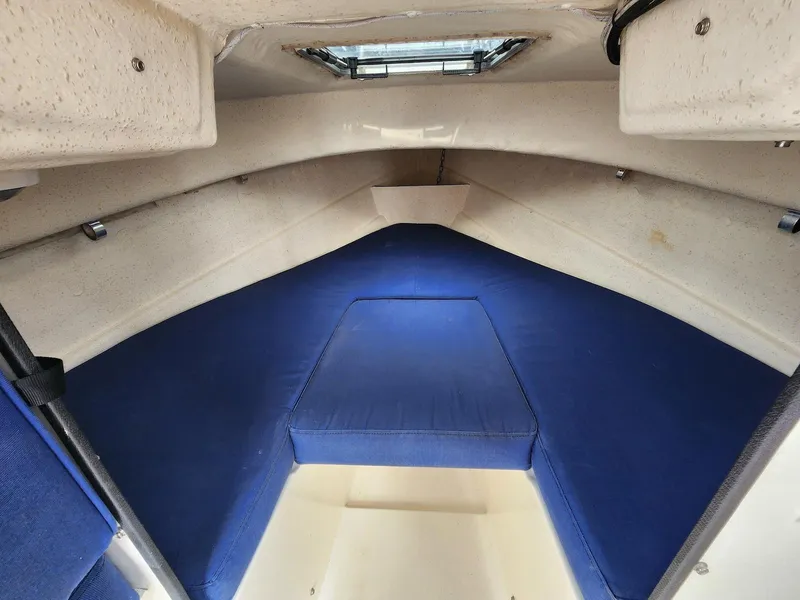 Slide: The Image of 2006 C-Dory 22 Cruiser interior with blue cushions and overhead hatch. - 13