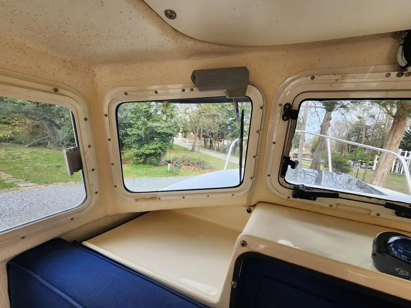 Slide: The Image of Interior view of 2006 C-Dory 22 Cruiser, showcasing windows and seating area. - 16