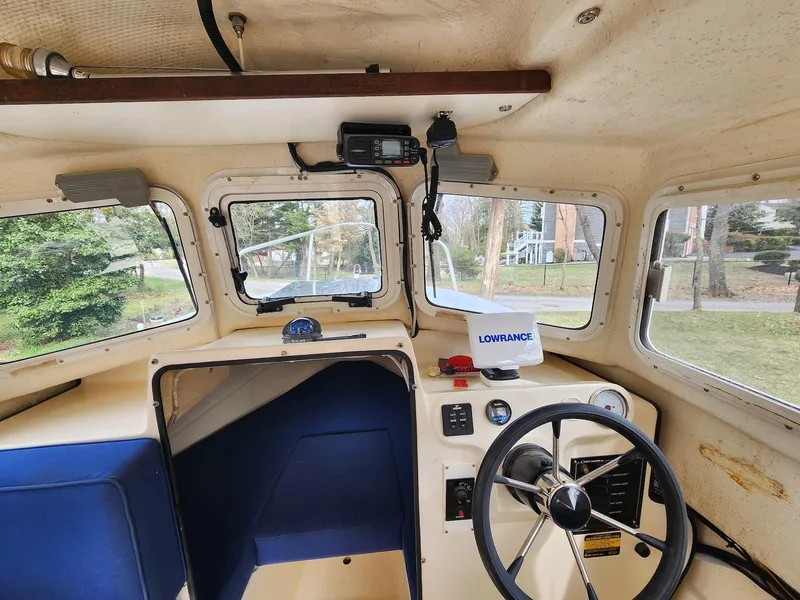 Slide: The Image of Interior of a 2006 C-Dory 22 Cruiser boat with steering wheel and navigation equipment. - 17