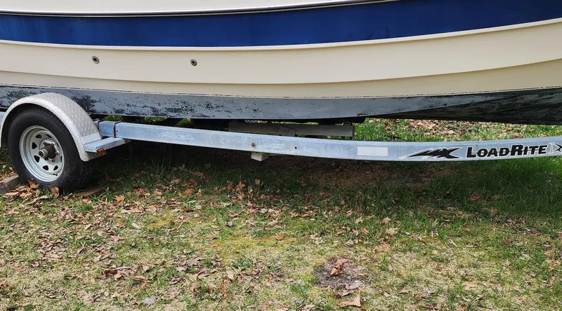 Slide: The Image of 2006 C-Dory 22 Cruiser on LoadRite trailer, parked on grass. - 4