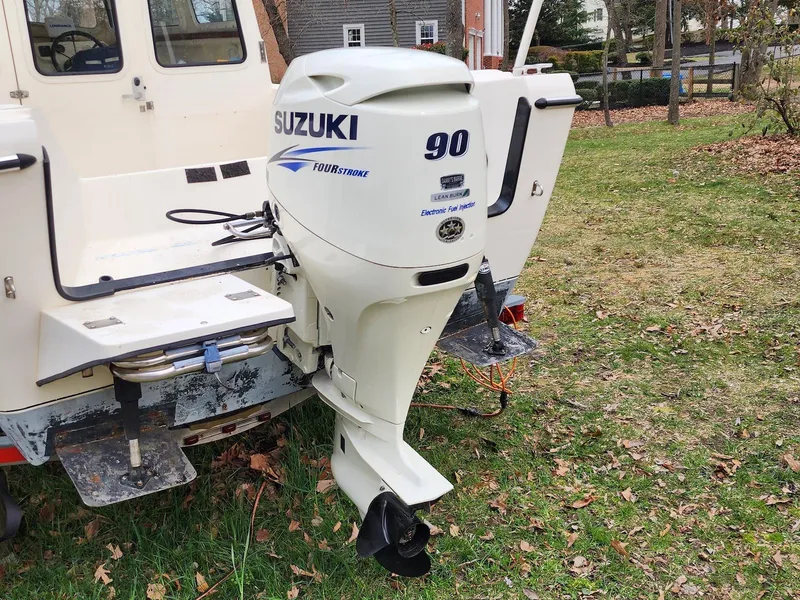Slide: The Image of 2006 C-Dory 22 Cruiser with Suzuki 90 outboard motor on grassy area. - 7