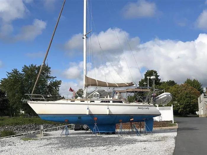 Slide: The Image of Catalina 42 MkII sailboat on land, 1989 model, with blue hull and white deck. - 2