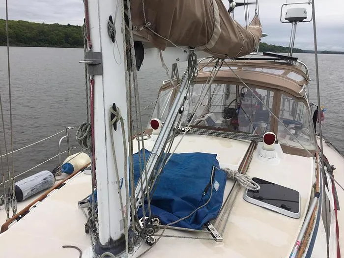 Slide: The Image of 1989 Catalina 42 MkII sailboat on calm water, featuring deck and rigging details. - 7