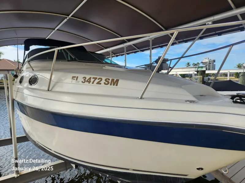 Slide: The Image of 1997 Regal 258 Commodore boat docked under canopy, side view. - 12