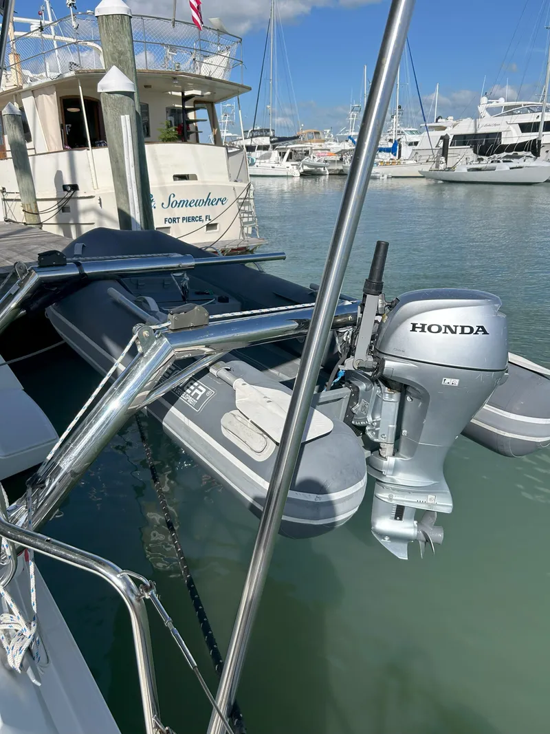 Slide: The Image of Docked Lagoon 40 catamaran with Honda outboard motor, 2020 model, in a marina setting. - 10