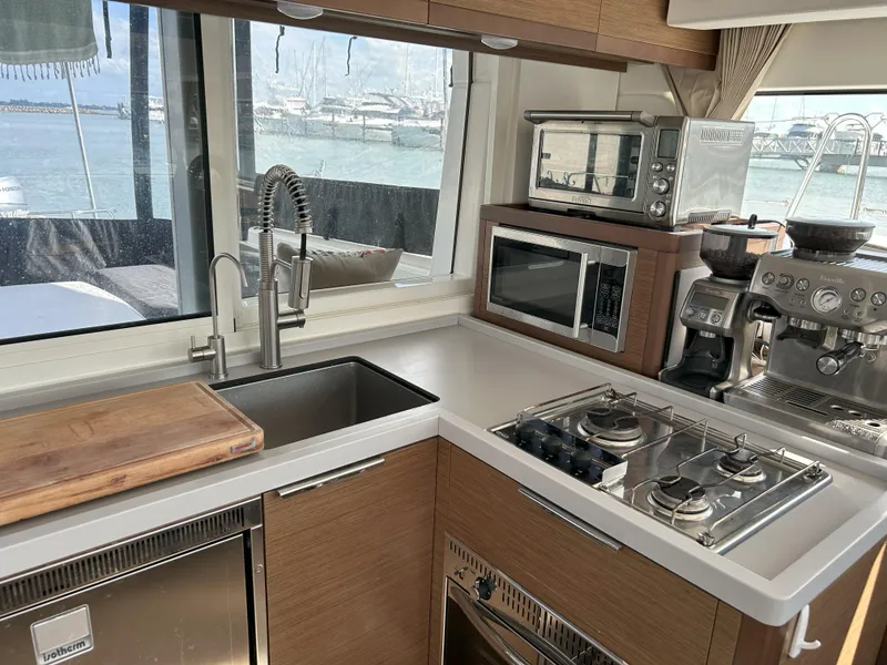 Slide: The Image of Modern kitchen in a 2020 Lagoon 40 yacht with appliances and ocean view. - 11
