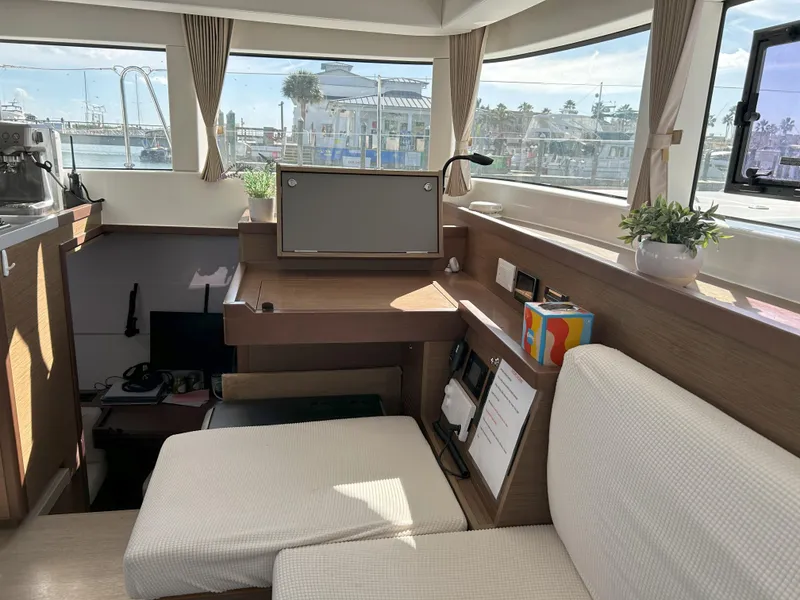 Slide: The Image of Interior of 2020 Lagoon 40 catamaran with modern seating and navigation area. - 12