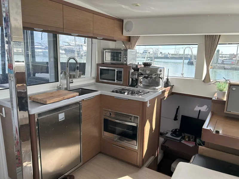 Slide: The Image of Modern kitchen interior of 2020 Lagoon 40 catamaran with appliances and marina view. - 13