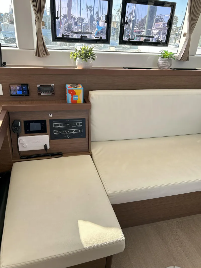 Slide: The Image of Interior of 2020 Lagoon 40 catamaran with beige seating and control panel. - 17