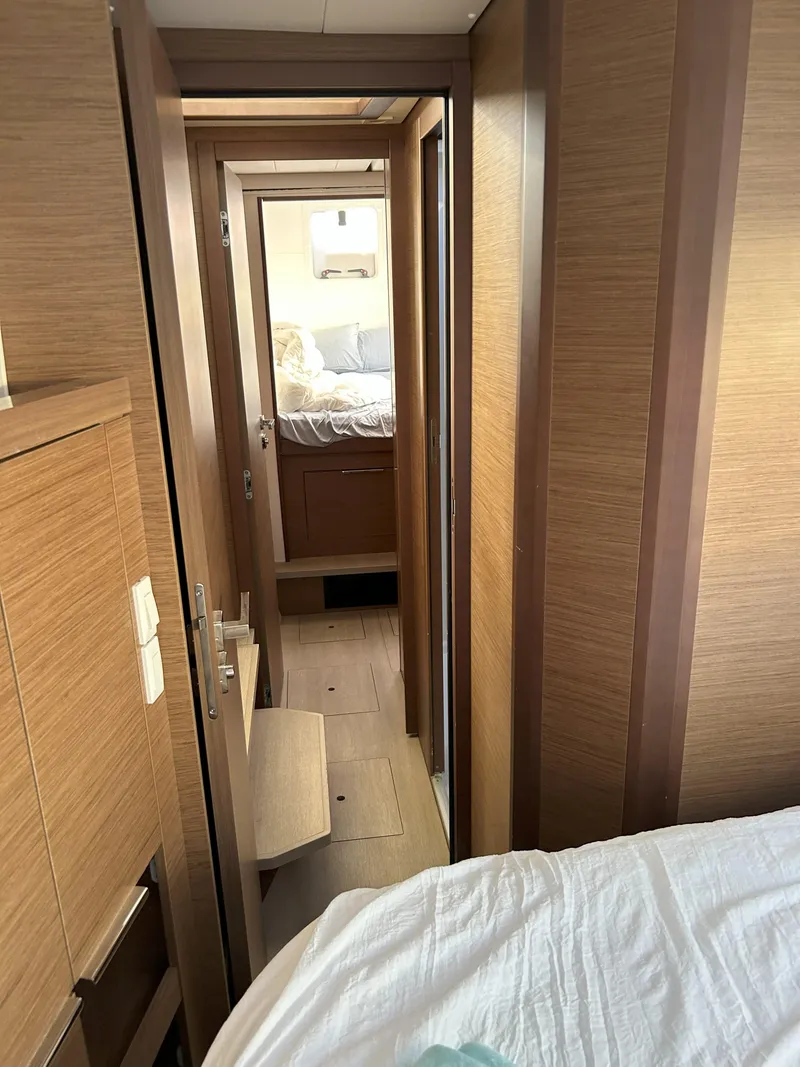 Slide: The Image of Interior hallway of 2020 Lagoon 40 catamaran with wood paneling and cozy cabin view. - 18