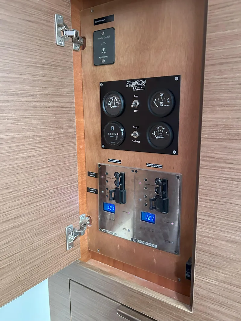Slide: The Image of Electrical panel inside a 2020 Lagoon 40 catamaran, featuring gauges and digital displays. - 26