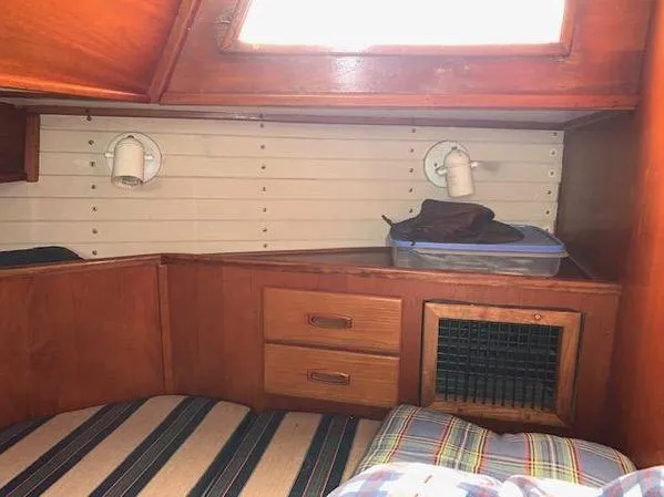 Slide: The Image of Cozy cabin interior of 1989 Custom SEA MAID boat with wooden drawers and striped bedding. - 15