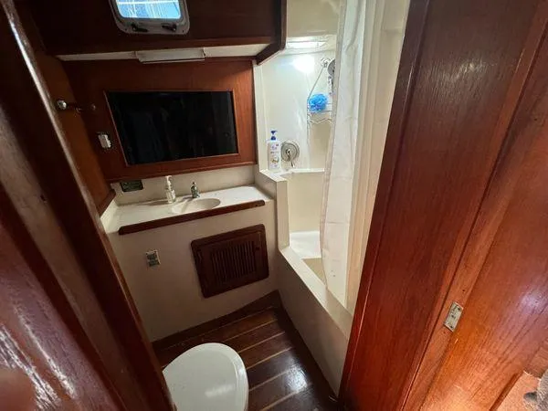 Slide: The Image of Compact bathroom in 1989 Custom SEA MAID boat with wood accents and shower. - 16