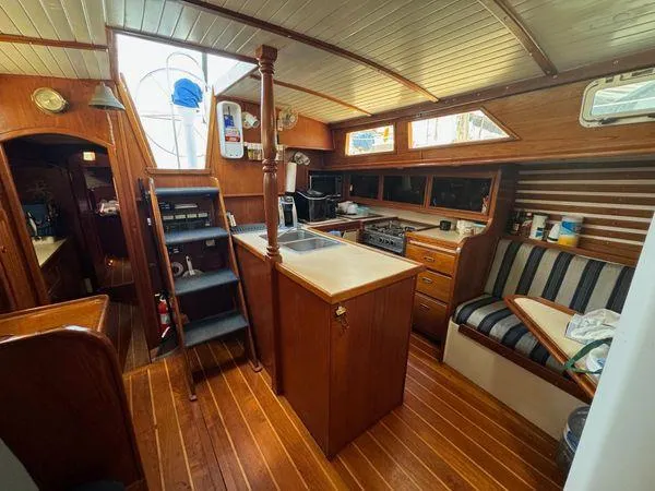 Slide: The Image of Interior of 1989 Custom SEA MAID boat with wooden cabinetry and striped seating. - 17