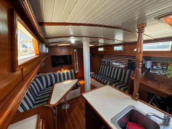 Slide: The Image of Interior of 1989 Custom SEA MAID boat with striped seating and wooden finishes. - 20