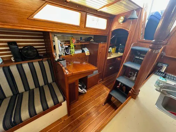 Slide: The Image of Cozy 1989 SEA MAID boat interior with wooden furnishings and striped seating. - 21
