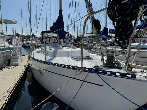 Slide: The Image of Sailboat "SEA MAID" 1989 model docked at marina, surrounded by other boats. - 3