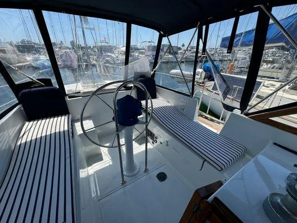 Slide: The Image of Interior view of 1989 Custom SEA MAID boat with striped seating and steering wheel. - 31