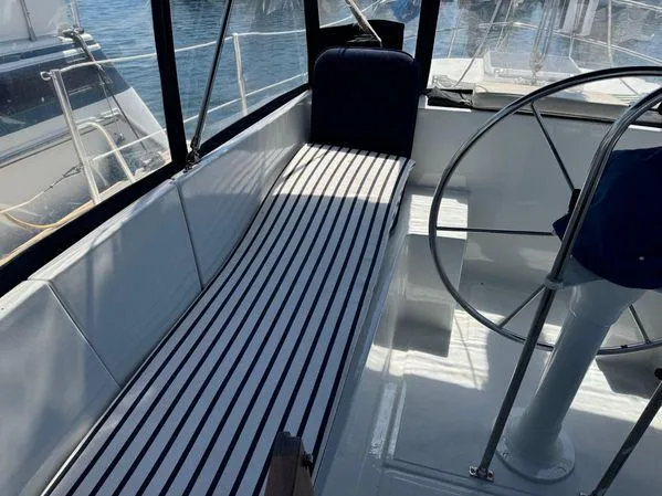 Slide: The Image of 1989 Custom SEA MAID boat interior with striped seating and steering wheel. - 33