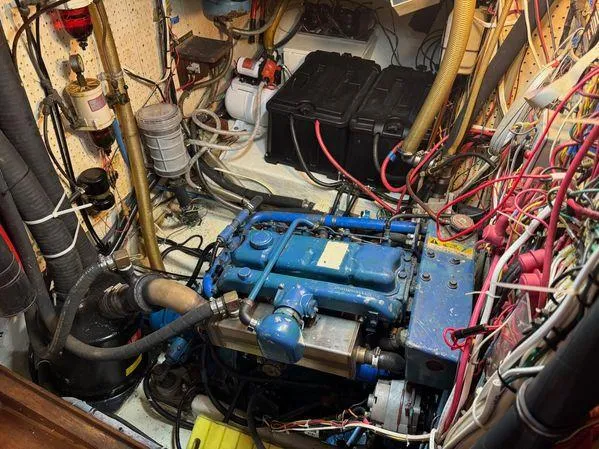 Slide: The Image of Engine room of 1989 Custom SEA MAID boat with blue engine and wiring. - 38