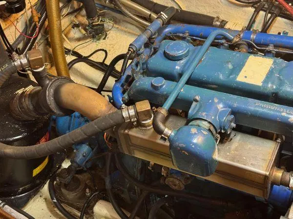 Slide: The Image of Engine room of 1989 Custom SEA MAID with blue machinery and hoses. - 39