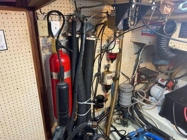 Slide: The Image of Engine room of Custom SEA MAID 1989 with fire extinguisher and hoses. - 41