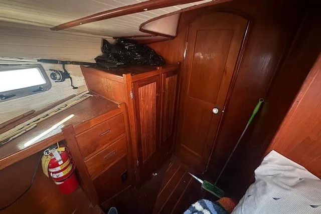 Slide: The Image of 1989 Custom SEA MAID boat interior with wooden cabinets and fire extinguisher. - 45