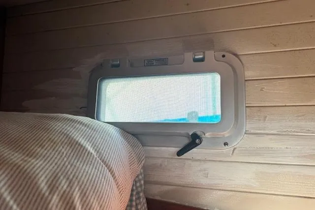 Slide: The Image of Interior of 1989 Custom SEA MAID with porthole window and bedding. - 47